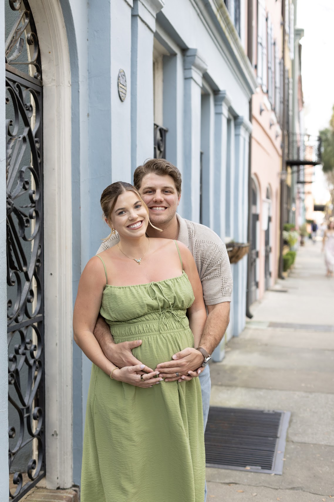 Maternity portrait of a couple along Charleston's Rainbow Row